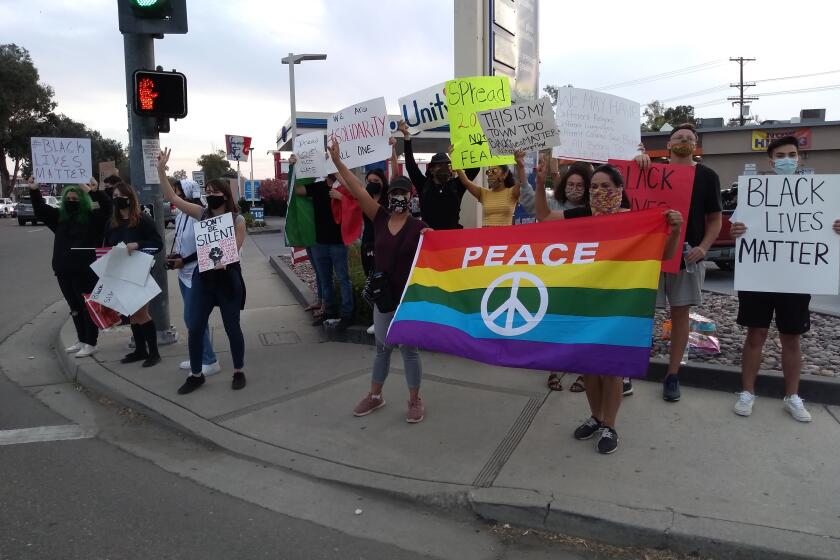 Protesters with signs who gathered in Ramona chanted but were mostly peaceful.