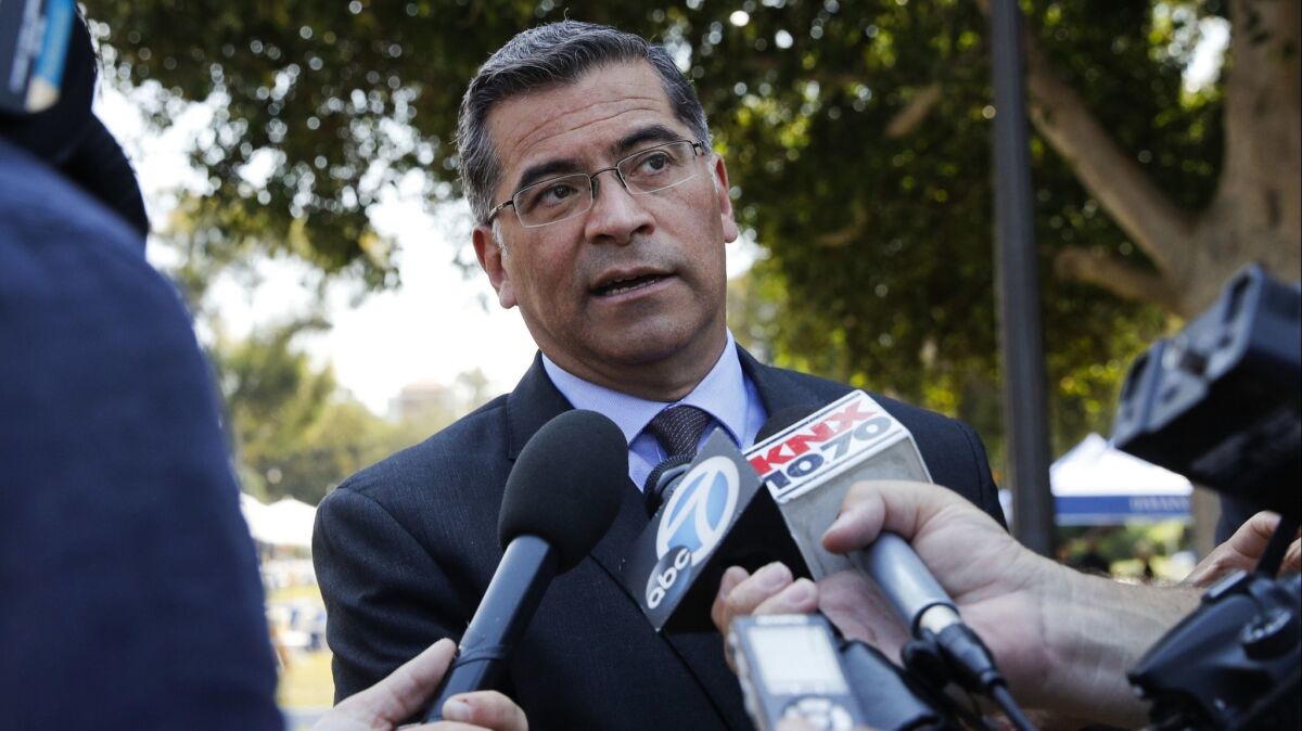 California Attorney General Xavier Becerra talks to reporters after a news conference at the University of California, Los Angeles on Aug. 2.