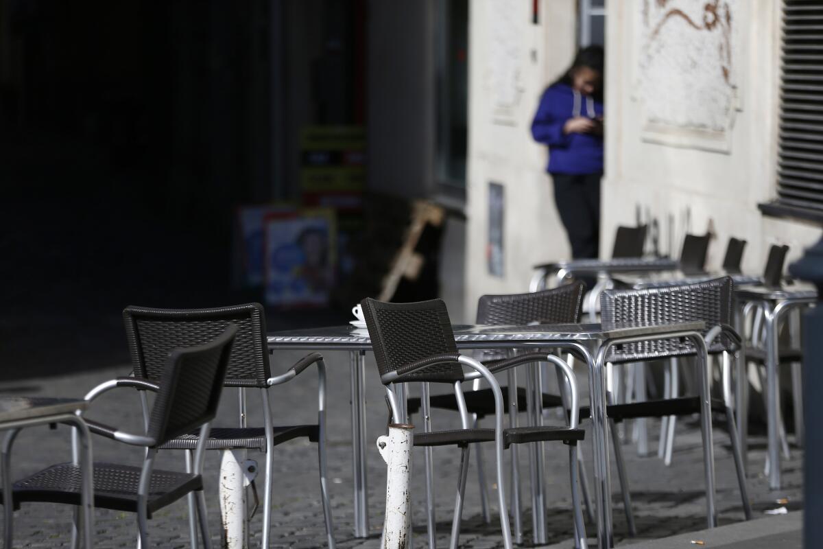 Empty chairs at a Rome cafe