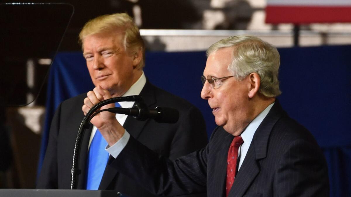 Senate Majority Leader Mitch McConnell (R-Ky.), right, speaks at a Kentucky rally last week as President Trump listens.