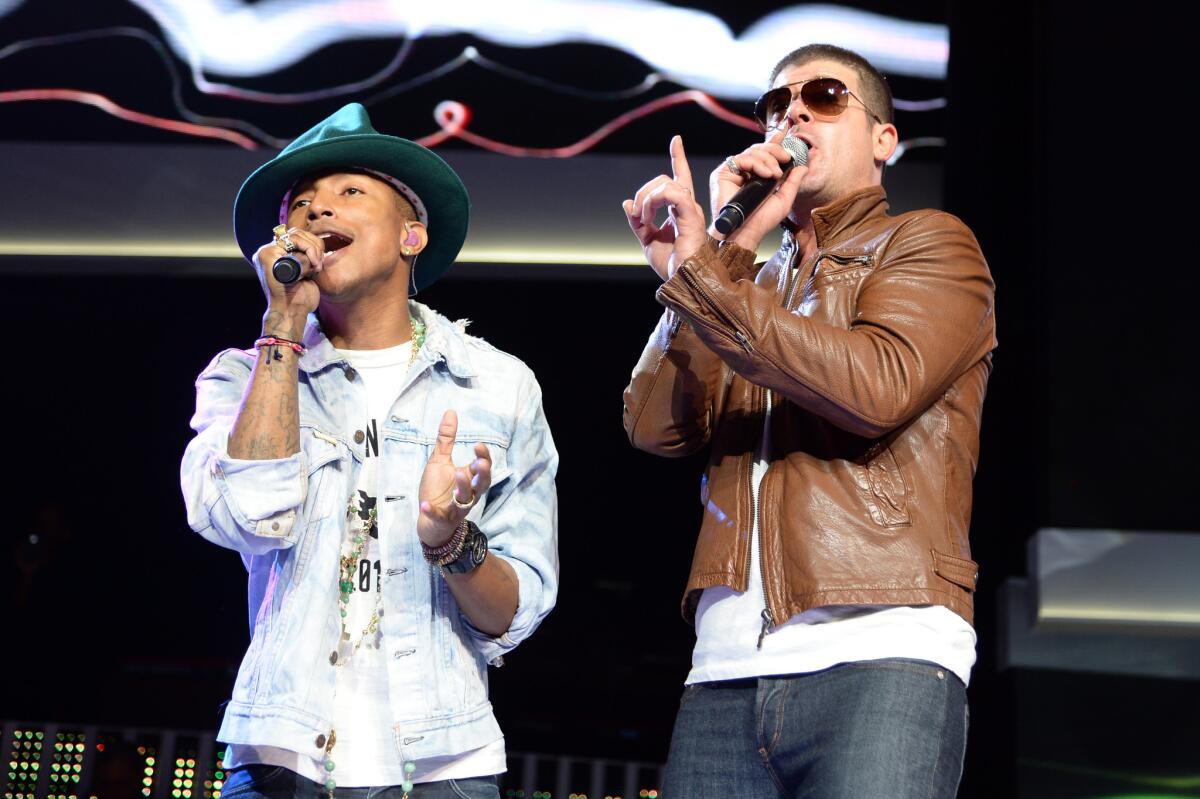 Pharrell Williams and Robin Thicke perform during the Walmart 2014 annual shareholders meeting on June 6.