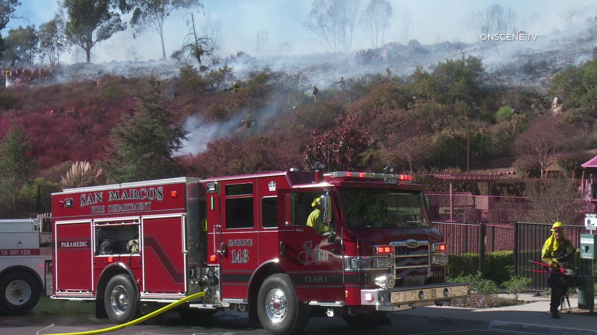 Crews work to douse a brush fire in San Marcos