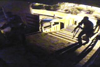 Officers coming up the steps to enter the Borderline Bar & Grill from a surveillance camera.