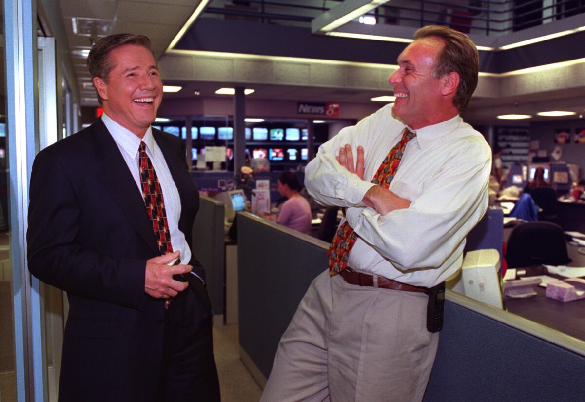 In this photo from 2000, Michael Tuck (left) chats with Larry Himmel.   