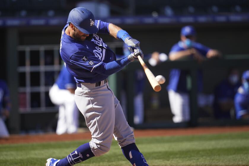 The Dodgers' Chris Taylor hits a grand slam in a spring training game against Kansas City on March 5, 2021.