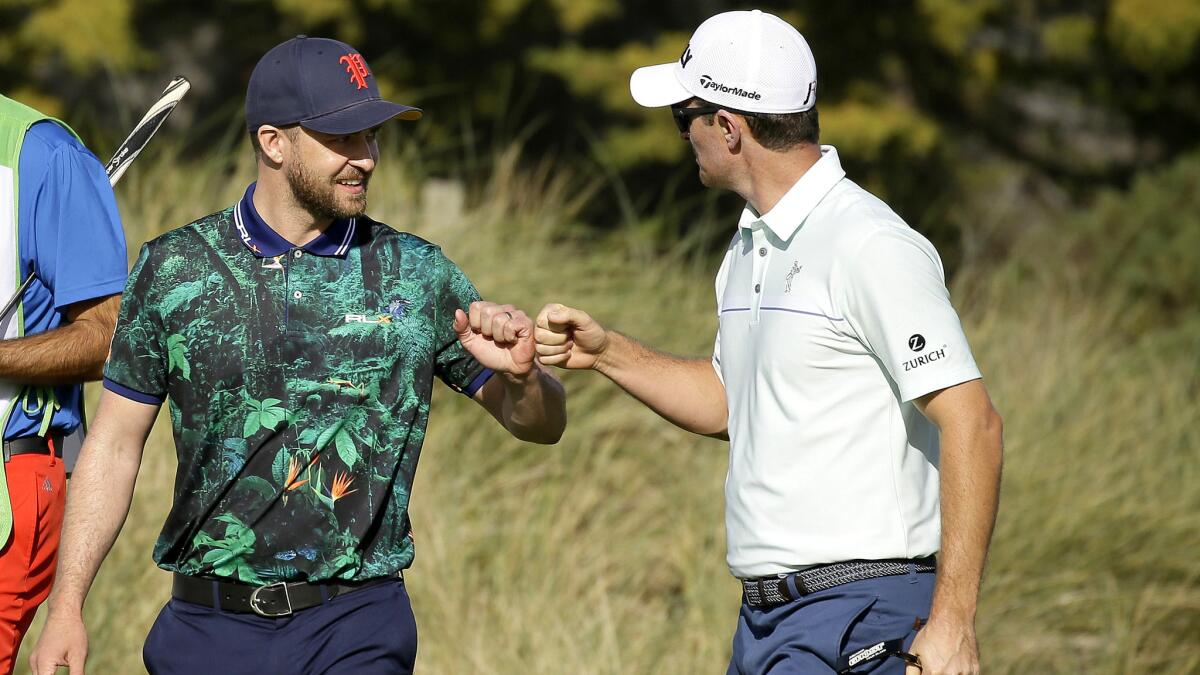 Justin Rose, right, is congratulated by playing partner Justin Timberlake after making a birdie on the fourth green at Spyglass Hill on Thursday.