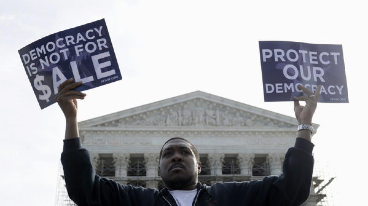 Cornell Woolridge of Windsor Mill, Md., takes part in a demonstration outside the Supreme Court in Washington.