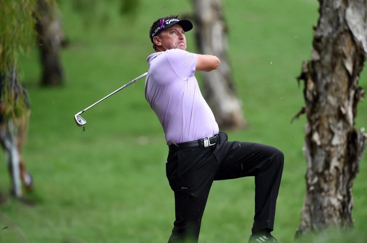 Robert Allenby hits out of the rough during the Australian PGA Championship at Royal Pines Resort on Dec. 12.