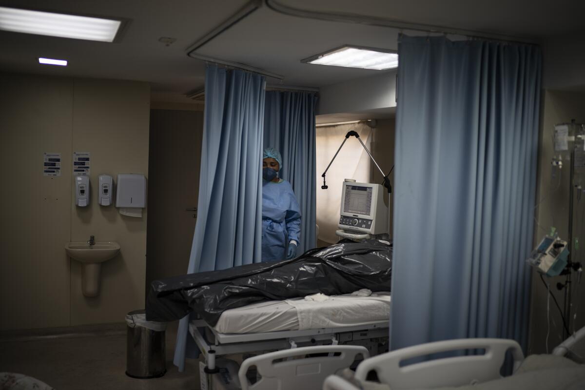 The body of a COVID-19 victim lies in a body bag in a hospital