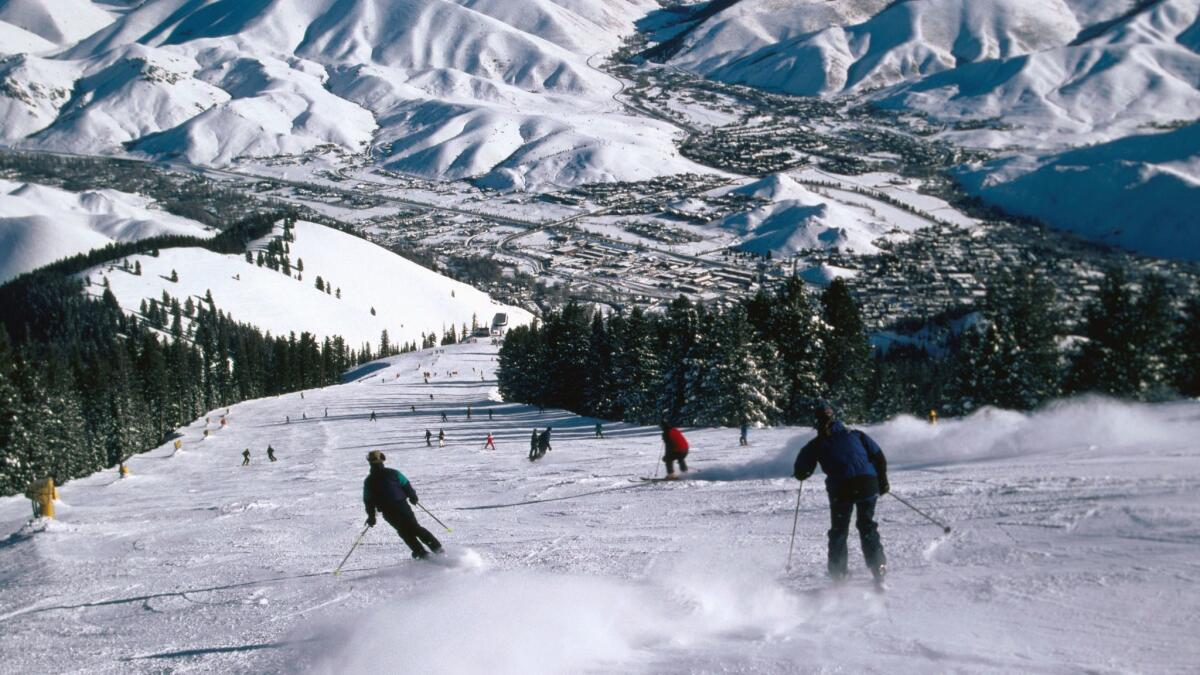 Downhill skiing on Bald Mountain slopes with town of Ketchum, Sun Valley, Idaho.