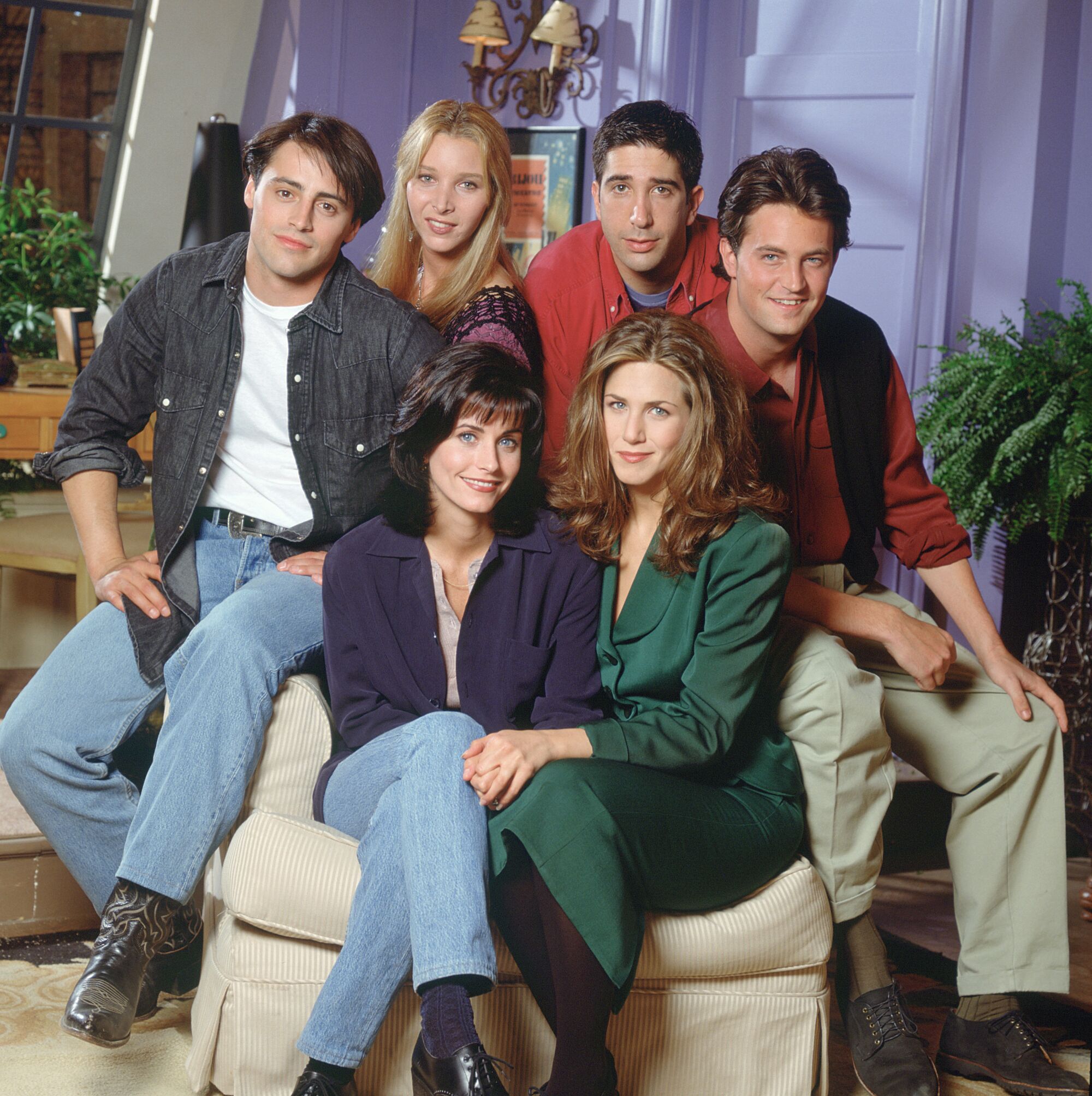 The stars of "Friends" seated in Monica's living room in Season 1.