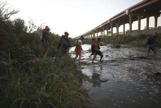 FILE - Venezuelan migrants walk across the Rio Bravo towards the United States border to surrender to the border patrol, from Ciudad Juarez, Mexico, Oct. 13, 2022. A surge in migration from Venezuela, Cuba and Nicaragua in September brought the number of illegal crossings to the highest level ever recorded in a fiscal year, according to U.S. Customs and Border Protection. (AP Photo/Christian Chavez, File)