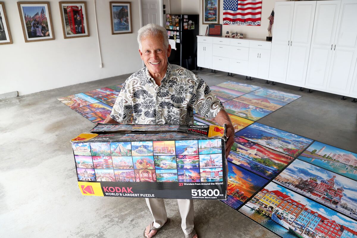 Newport Beach resident Ken St. Sure, 78, spent over a year assembling a Kodak World's Largest Puzzle in his garage.