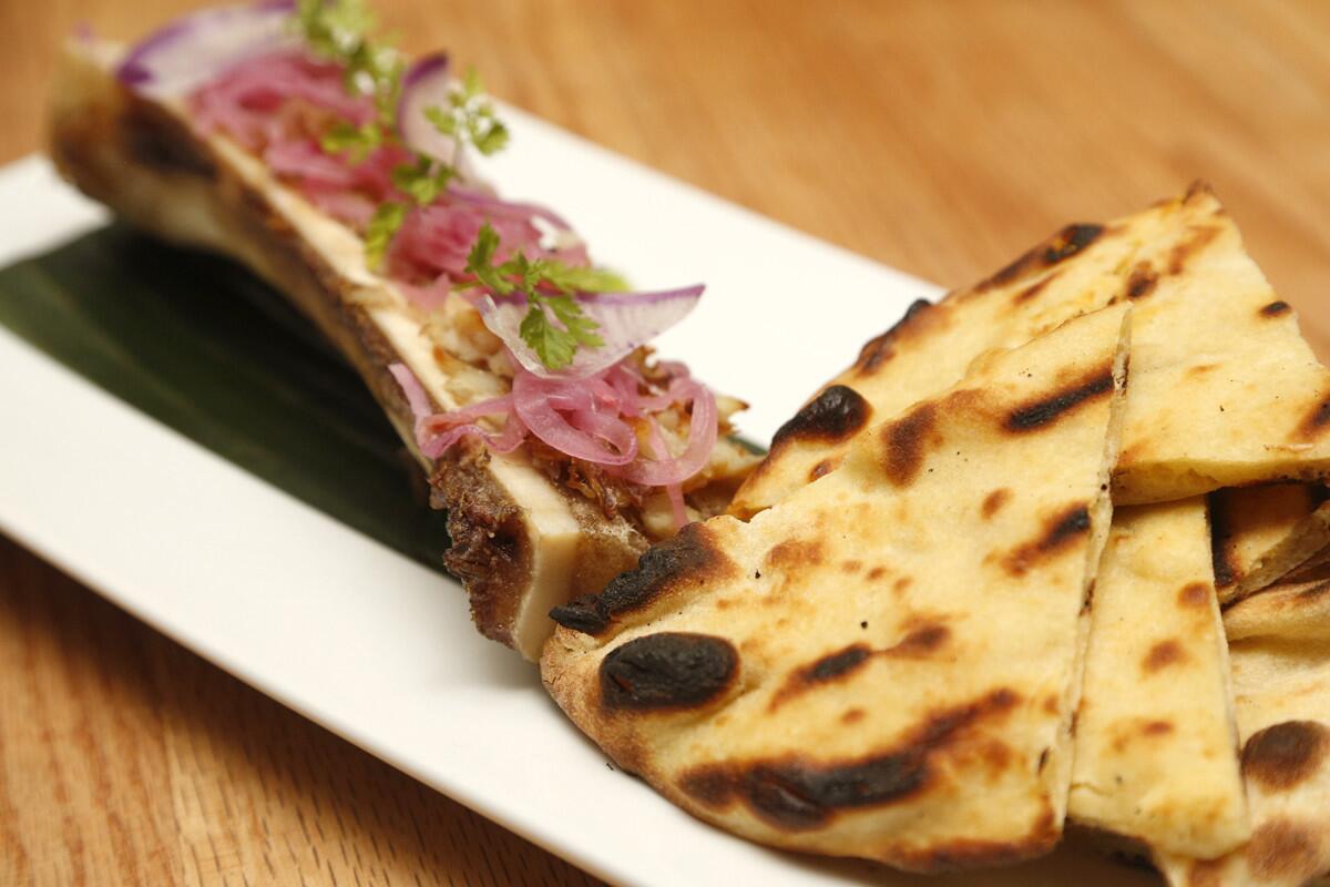 Blind daters Scott Schindler and Zlata Sushchik ordered the Smoked Hake; bone marrow, red onion escabeche and served grilled naan. (David Brooks / Union-Tribune).
