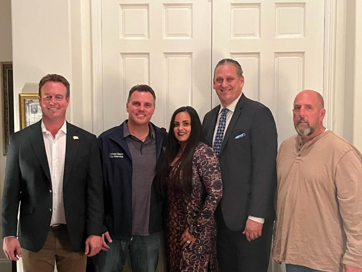 Casey McKeon, City Atty. Michael Gates, Gracey Van Der Mark, Tony Strickland and Pat Burns pose for a photo at Gates' home.