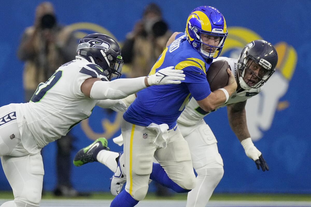 Rams quarterback John Wolford is tackled by Seattle Seahawks linebacker Uchenna Nwosu.