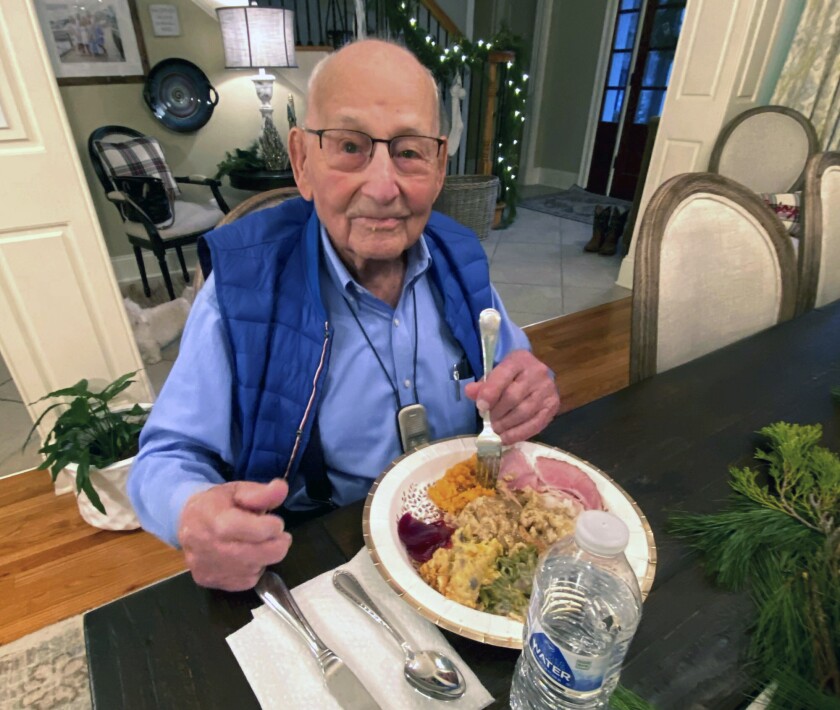 In this photo provided by Holly McDonald, World War II veteran Major Wooten enjoys his Thanksgiving dinner with family in Madison, Ala., on Thursday, Nov. 25, 2021. Wooten, who served in France during the war, will be presented with the French Legion of Honor during his 105th birthday party on Friday, Dec. 3, 2021. (Holly McDonald via AP)