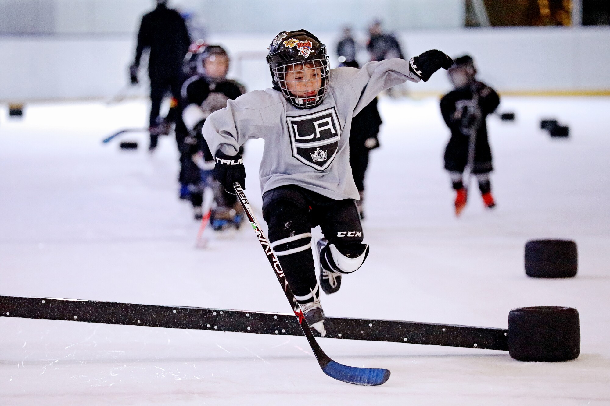 Players with the Mexico City Jr. Kings youth hockey league skate through training drills March 23, 2022, in Mexico City.