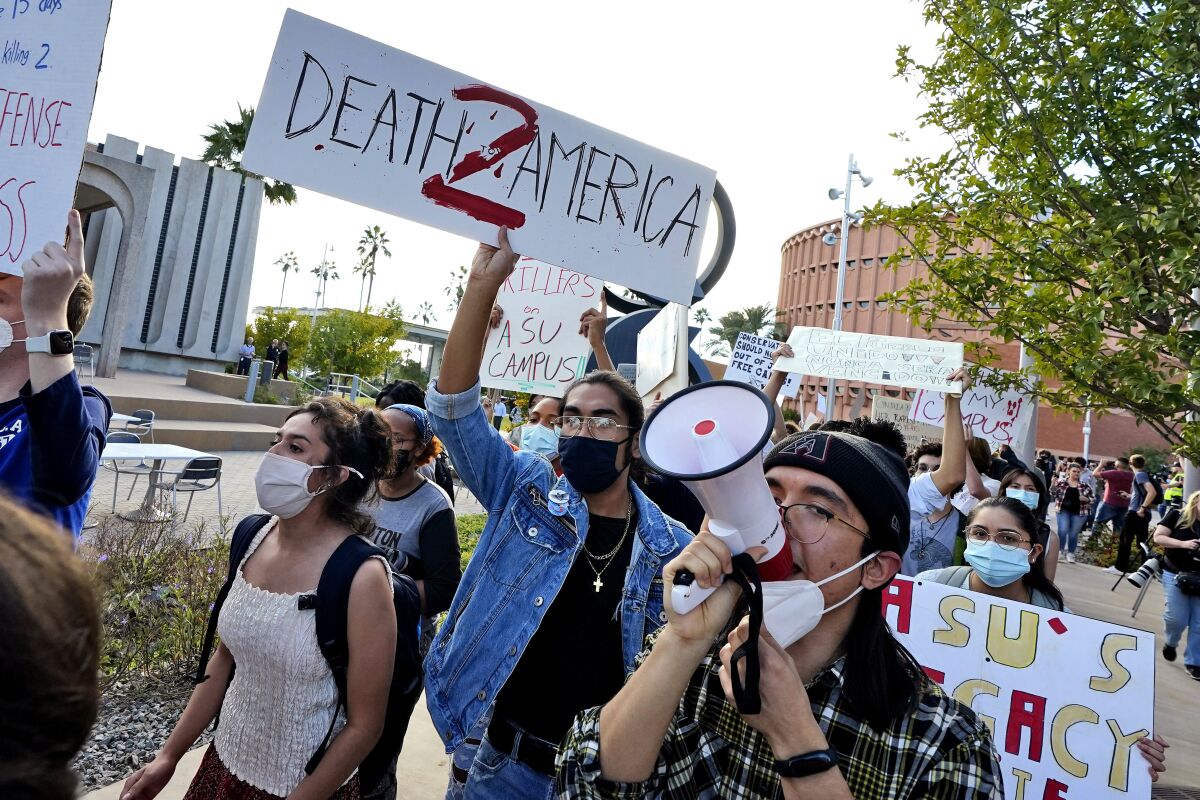 Students for Socialism protest on campus demanding that Kyle Rittenhouse not be allowed to enroll at Arizona State University, Wednesday, Dec. 1, 2021, at ASU in Tempe, Ariz. Protesters were demanding the university disavow the 18-year-old, who was acquitted of murder last month in the deadly shootings during last year's unrest in Kenosha. (AP Photo/Matt York)