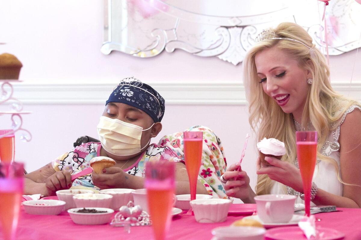 Ashley Antunez, 13, and Casey Reinhardt from the Food Network’s “Cupcake Wars” add frosting and decorations during a birthday celebration for Ashley on Thursday at Casey’s Cupcakes in Irvine.
