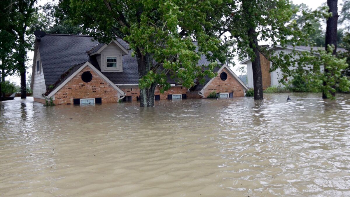 A home is surrounded by floodwaters from Tropical Storm Harvey in Spring, Texas, on Aug. 28.