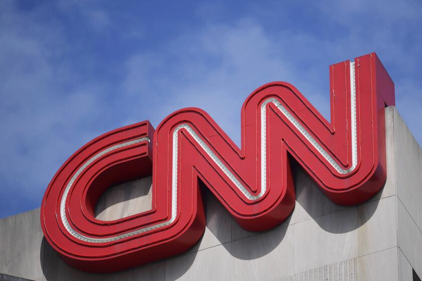FILE - Signage hangs at CNN center, April 21, 2022, in Atlanta. Alice Stewart, a CNN political commentator and veteran political adviser who worked on a number of GOP presidential campaigns, has died at age 58, the news network reported Saturday, May 18, 2024. (AP Photo/Mike Stewart, File)