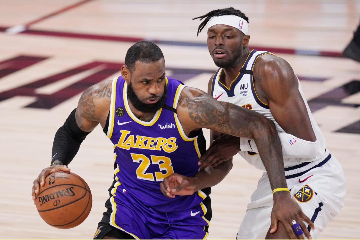 Lakers' LeBron James drives against Denver Nuggets' Jerami Grant.