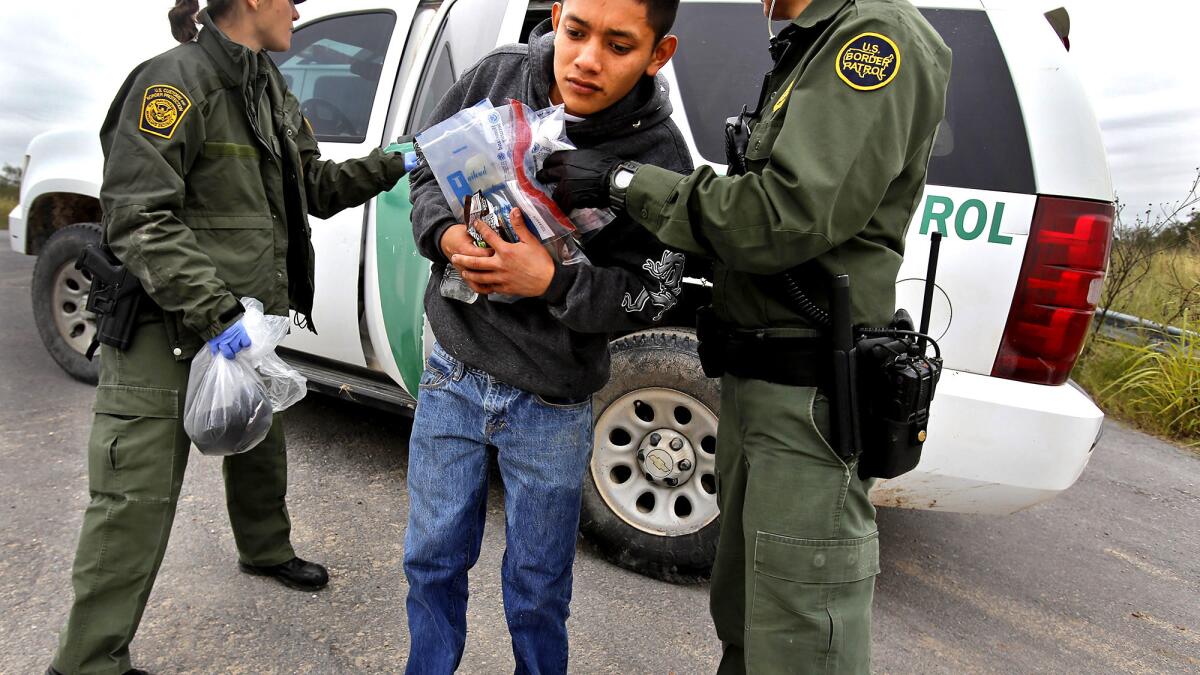A 17-year-old Guatemalan is removed from a U.S. Border Patrol vehicle south of McAllen, Texas. Although immigration from Central America has increased, the overall number of immigrants living in the U.S. illegally is at its lowest in more than a decade.