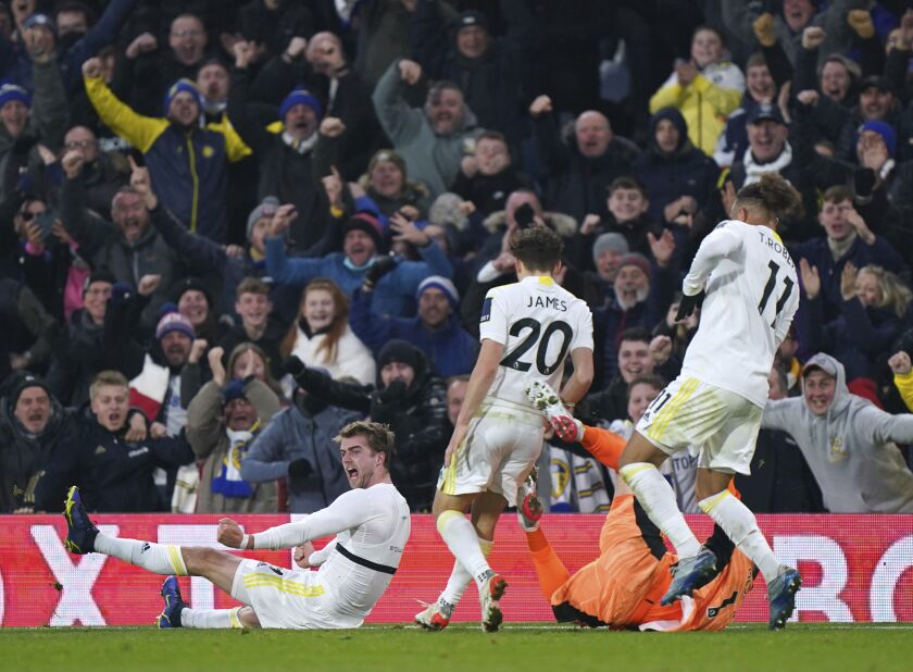 Leeds United's Patrick Bamford, left, celebrates scoring his side's second goal of the game, during the English Premier League soccer match between Leeds United and Brentford FC at Elland Road, in Leeds, England, Sunday, Dec. 5, 2021. (Tim Goode/PA via AP)