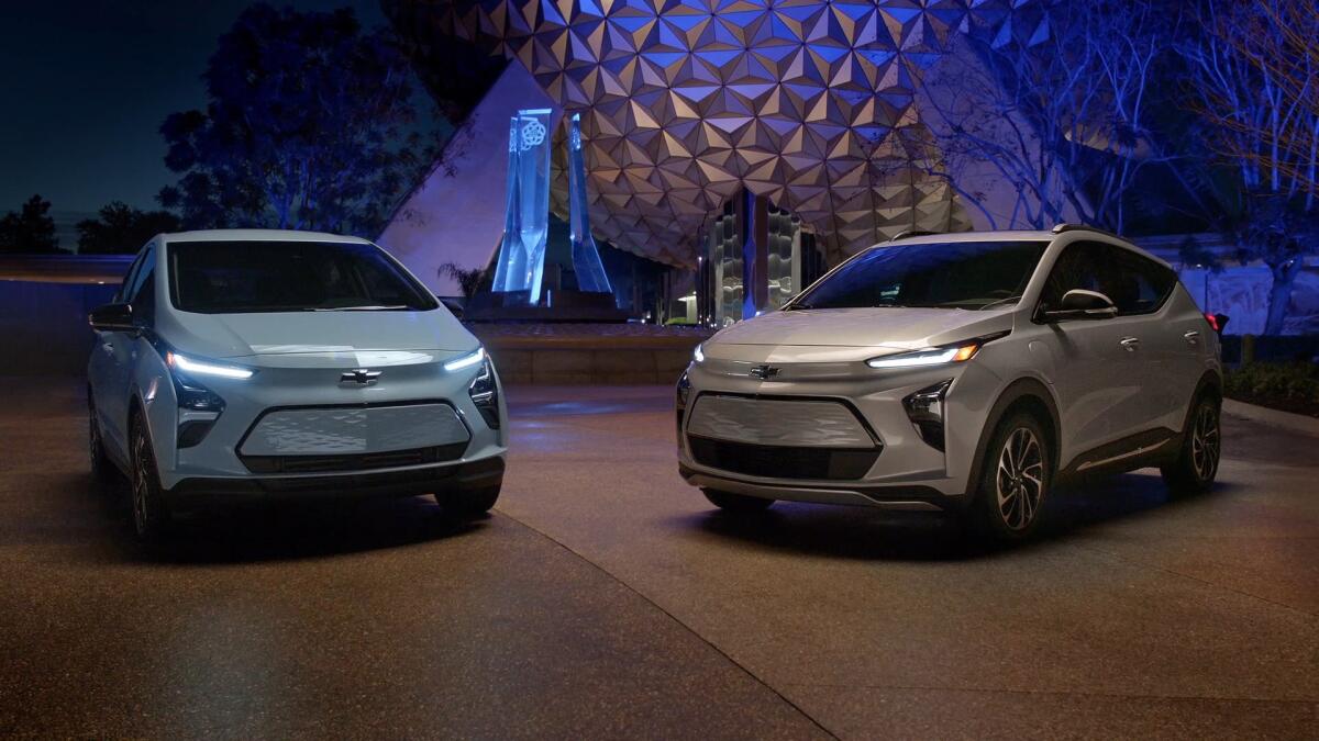 A nighttime photo of two electric vehicles at Epcot