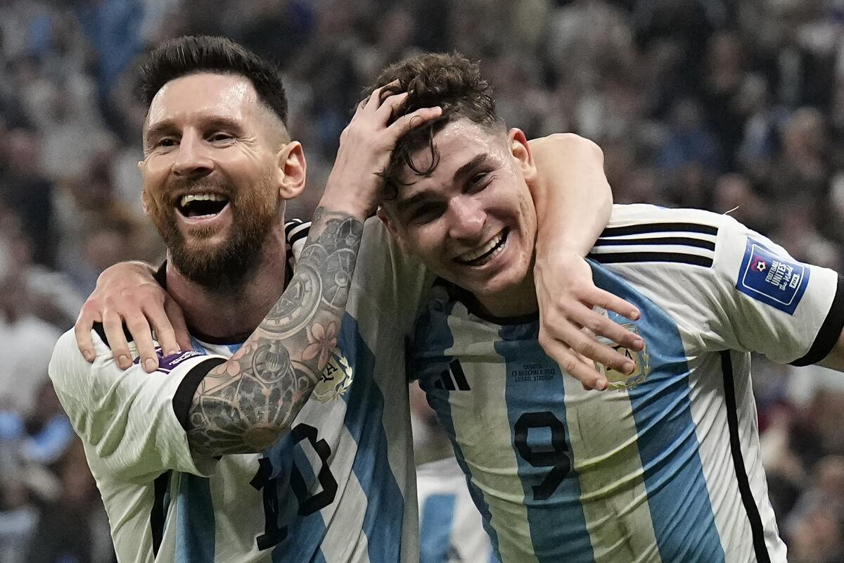 Argentina's Lionel Messi, left, and Argentina's Julian Alvarez celebrate after scoring during the World Cup semifinal soccer match between Argentina and Croatia at the Lusail Stadium in Lusail, Qatar, Tuesday, Dec. 13, 2022. (AP Photo/Martin Meissner)