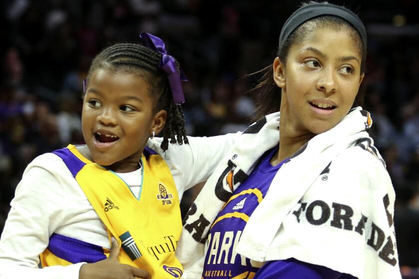 Los Angeles Sparks forward Candace Parker holds her daughter Lailaa Nicole Williams after the Game 2 of a WBNA basketball semifinal against Chicago Sky in Los Angeles, Friday, Sept. 30, 2016. The Sparks won 99-84. (AP Photo/Ringo H.W. Chiu)