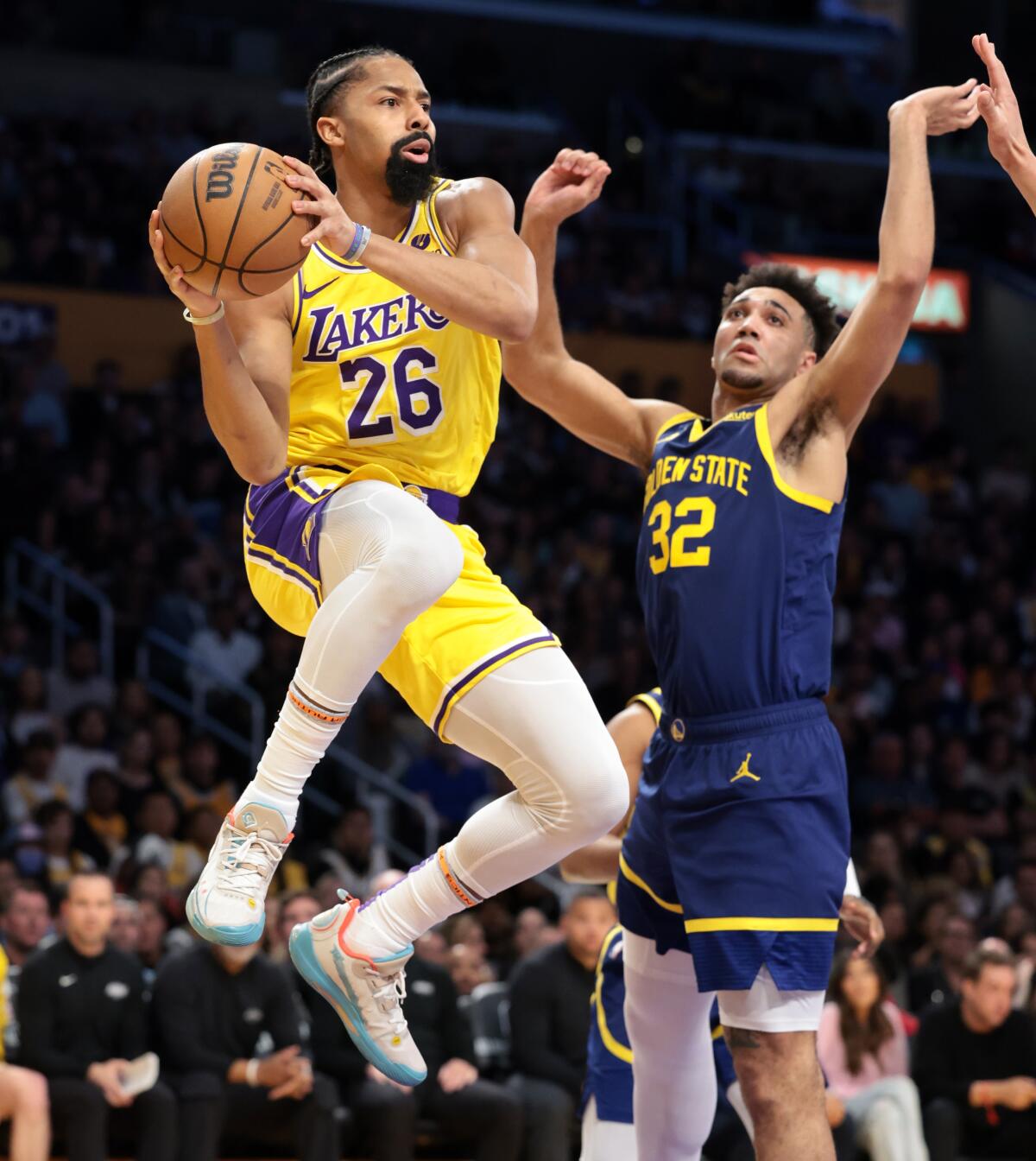 Lakers guard Spencer Dinwiddie leaps along the baseline to make a pass during the game against the Warriors on Tuesday.