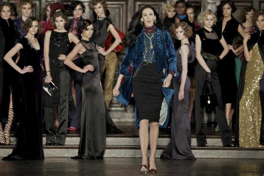 Designer L'Wren Scott, center, shown after her Fall 2012 collection was modeled during Fashion Week, in New York, was found dead Monday, March 17, 2014, in Manhattan of a possible suicide.