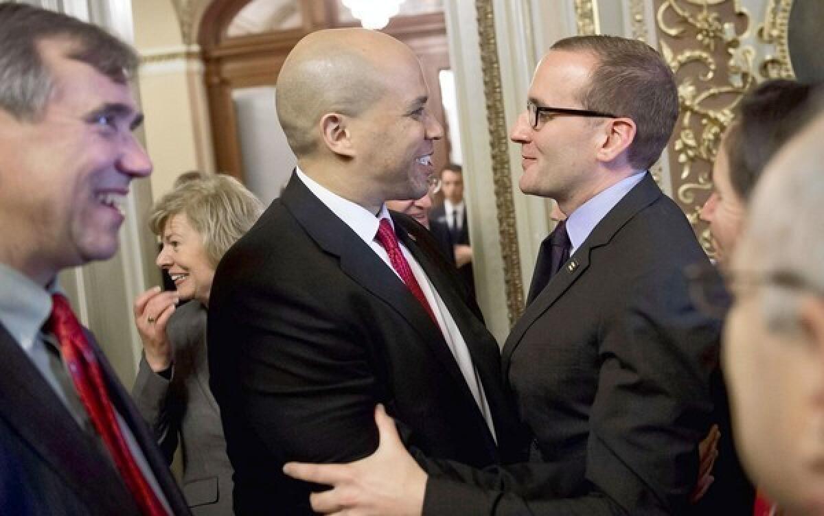 Sens. Jeff Merkley (D-Ore.) and Cory Booker (D-N.J.) with Human Rights Campaign President Chad Griffin, from left, after the Employment Non-Discrimination Act passed with the help of 10 Republicans.