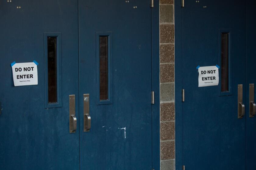 BOTHELL, WA - FEBRUARY 27: Do not enter signs are seen taped to doors at Bothell High School on February 27, 2020 in Bothell, Washington. School district officials decided to close the school for disinfecting after a family member of a school staffer was quarantined for possible coronavirus. (Photo by David Ryder/Getty Images)
