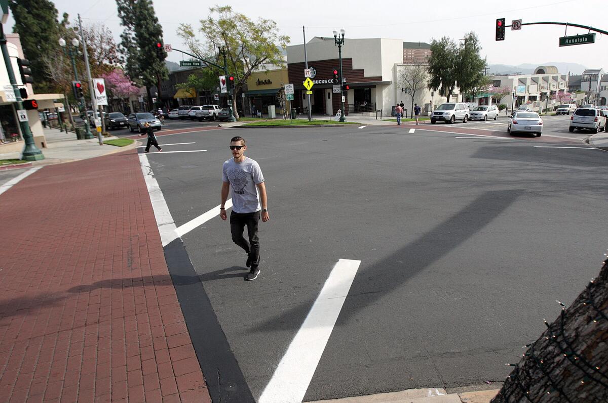 An unidentified Montrose resident crosses a new diagonal crosswalk at the intersection of Ocean View Blvd. and Honolulu Avenue on Friday, February 20, 2015.