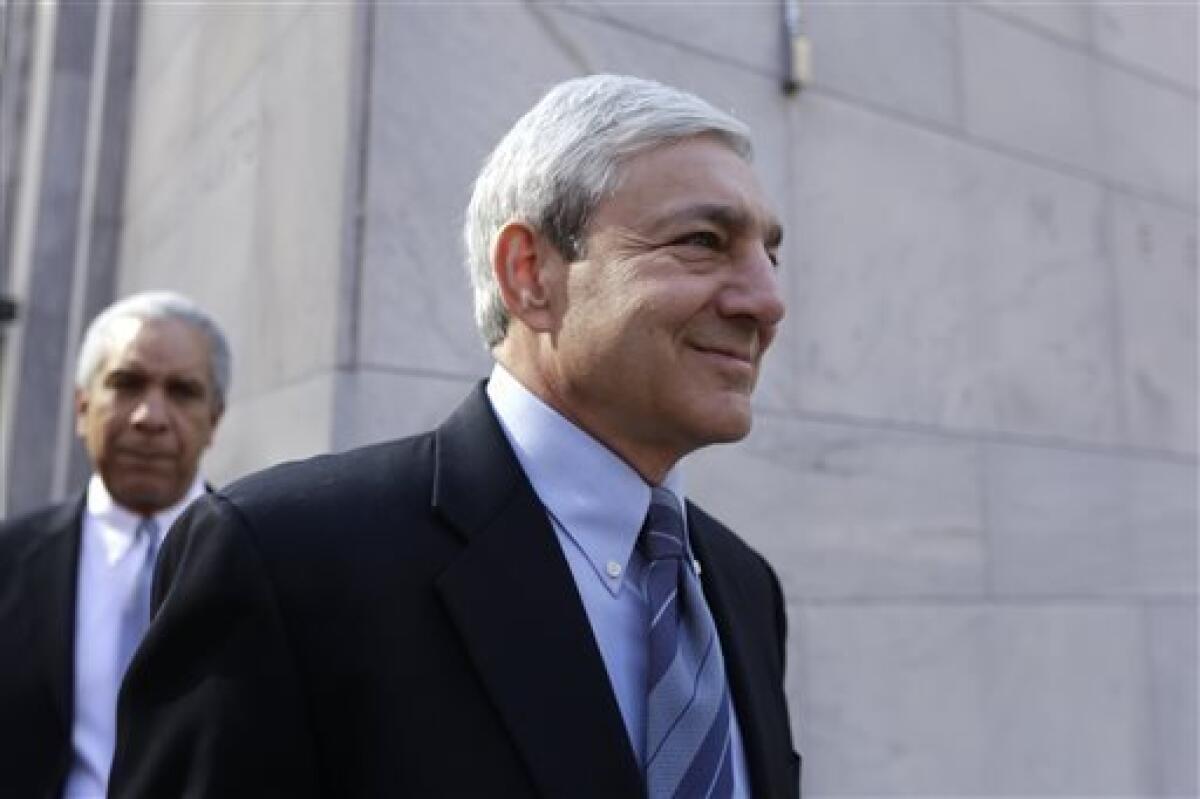 Former Penn State president Graham Spanier exits the Dauphin County Courthouse, Monday, July 29, 2013, in Harrisburg, Pa. Spanier faces charges in the child sex abuse scandal involving former assistant football coach Jerry Sandusky. (AP Photo/Matt Rourke)