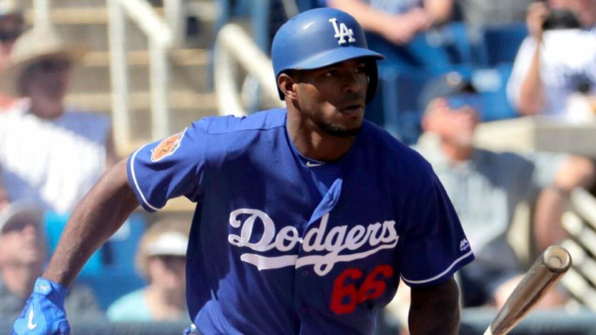 Dodgers outfielder Yasiel Puig hits against the Brewers during a spring training game on March 8.