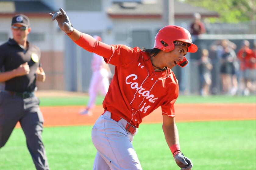 Anthony Murphy of Corona High rounds the bases after hitting a home run.