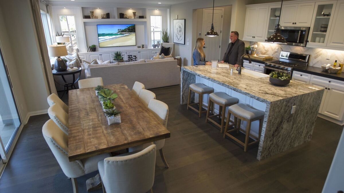 The kitchen and dining area in a 2,314 square foot farmhouse style four bedroom single family home in the Valencia section of the Escaya development in Otay Ranch in the city of Chula Vista.