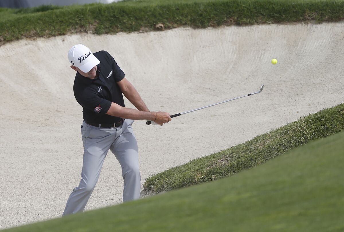 Rob Labritz hits from the bunker on the 18th hole during the Hoag Classic golf tournament on Saturday.