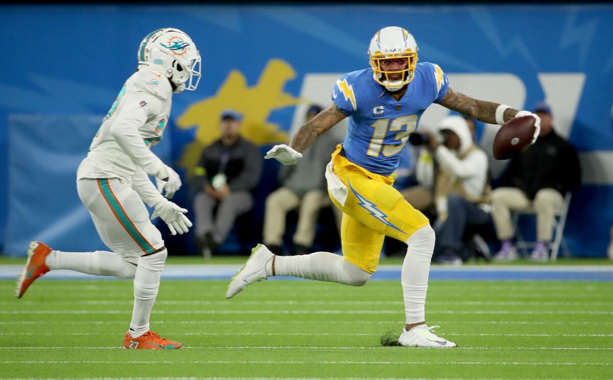 Chargers receiver Keenan Allen runs for yardage after a making catch against coverage by Miami corner Deion Crossen.