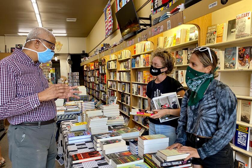 Eso Won Books co-owner James Fugate speaks with customers