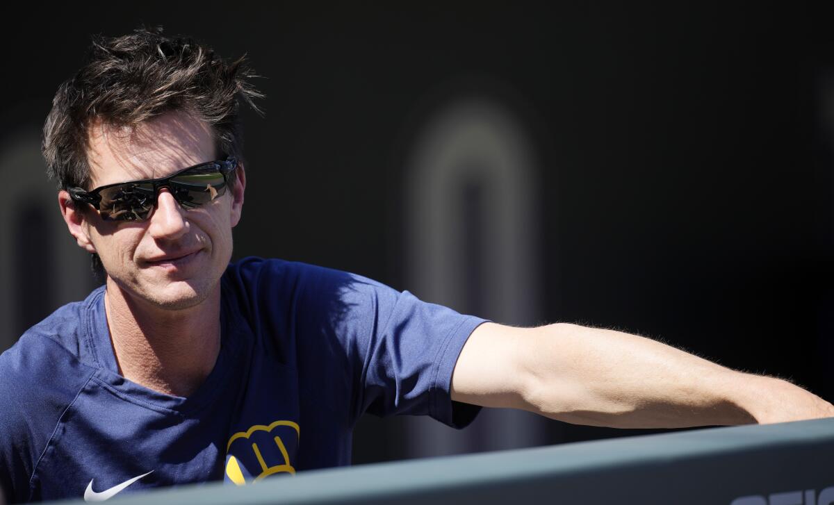 Milwaukee Brewers manager Craig Counsell looks on from the dugout as players warm up before a baseball game against the Colorado Rockies Monday, Sept. 5, 2022, in Denver. (AP Photo/David Zalubowski)