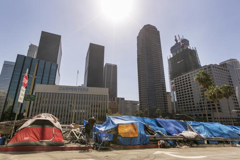 Tents used by the homeless line a downtown street on Sept. 22. City officials say they will declare a state of emergency on homelessness and propose spending $100 million to reduce the number of people living on L.A.'s streets.