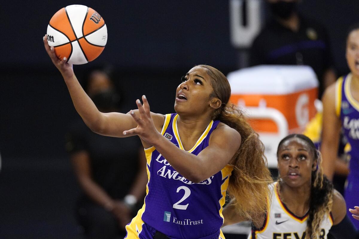 Los Angeles Sparks guard Te'a Cooper, left, shoots as Indiana Fever guard Tiffany Mitchell defends during the first half of a WNBA basketball game Thursday, June 3, 2021, in Los Angeles. (AP Photo/Mark J. Terrill)