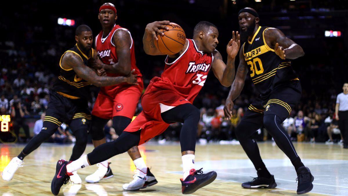 Trilogy's Rashard McCants (32) handles the ball against Killer 3s' Reggie Evans (30) during week one of the Big3 three-on-three basketball league on Sunday.