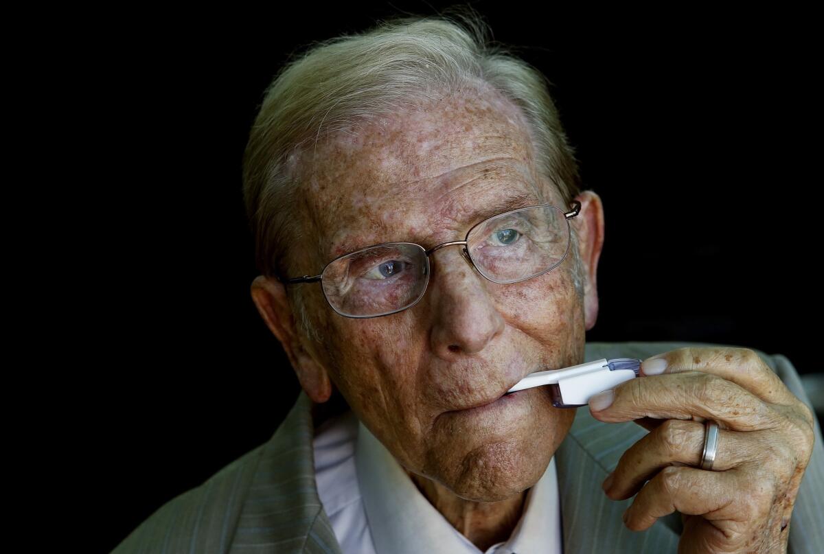 MannKind founder Alfred Mann demonstrates the device used to inhale Afrezza.