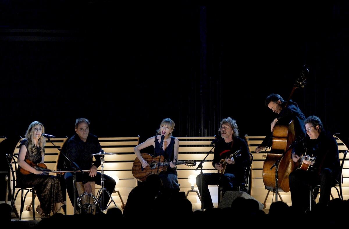 From left, Alison Krauss, Eric Darken, Taylor Swift, Sam Bush, Edgar Meyer and Vince Gill perform during the 47th annual CMA Awards.